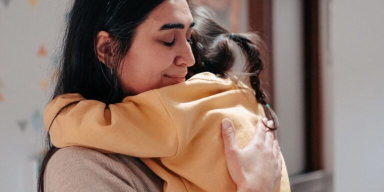 mom hugging child looking content parent mental health