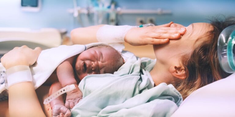 mother crying holding baby in hospital after birth discarding placentas