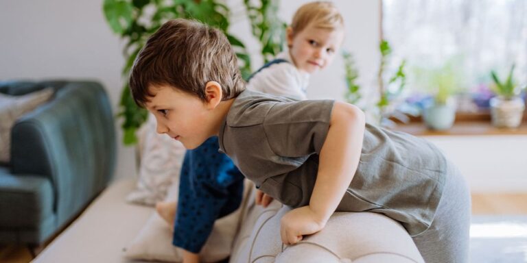 siblings playing on the couch